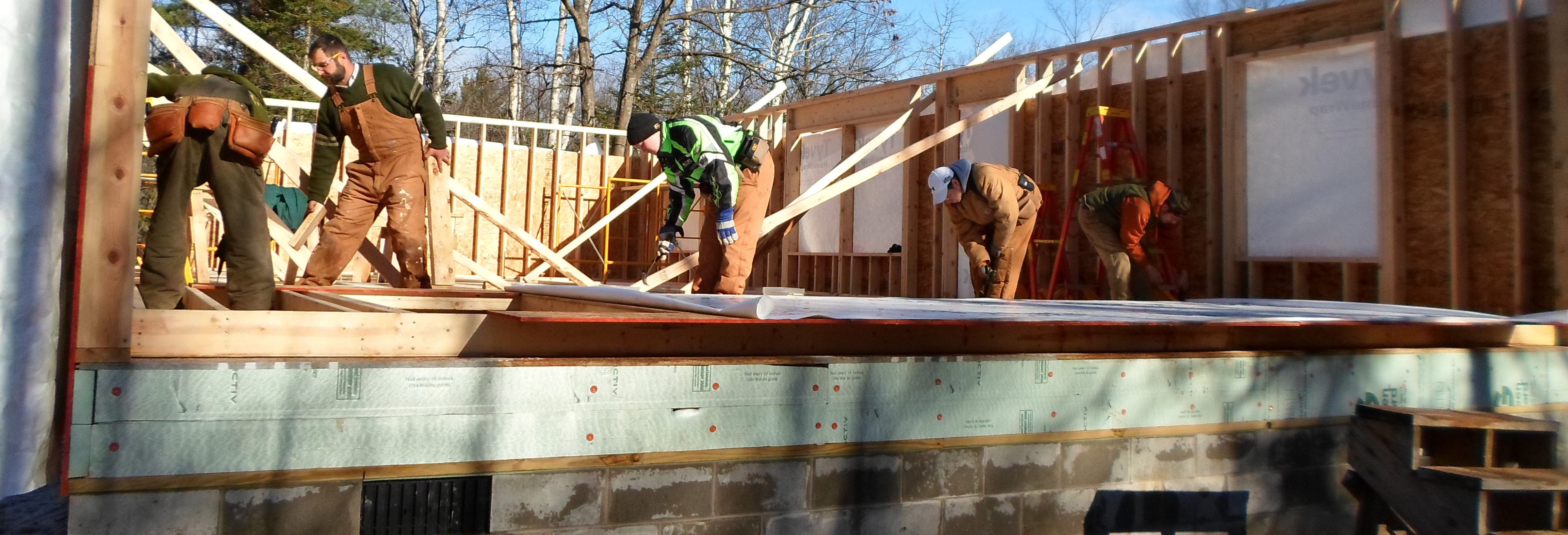 Students and Instructor working on building frame to a house